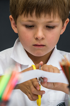 Image of a student cutting paper