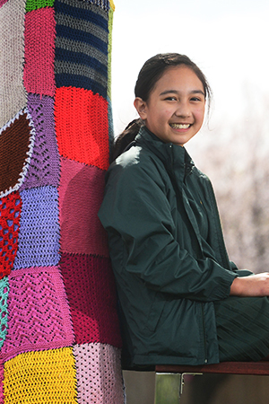 Image of a happy student sat down