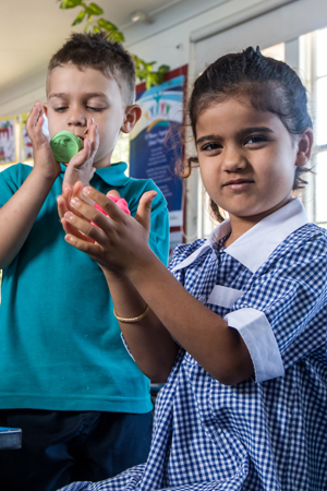 primary age boy & girl playing with playdoh