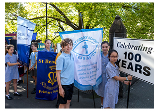 Students at Catholic Education Week, holding banners.