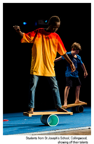 St Joseph's Collingwood students balance on a plank on stage