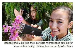 Students from Ss Peter and Paul School take their portable microscopes outside