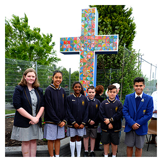 Students standing with the cross