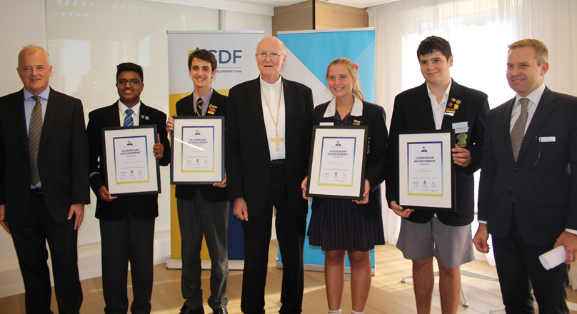 Arch Bishop and students receiving their awards