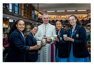 Archbishop Comensoli with some students.