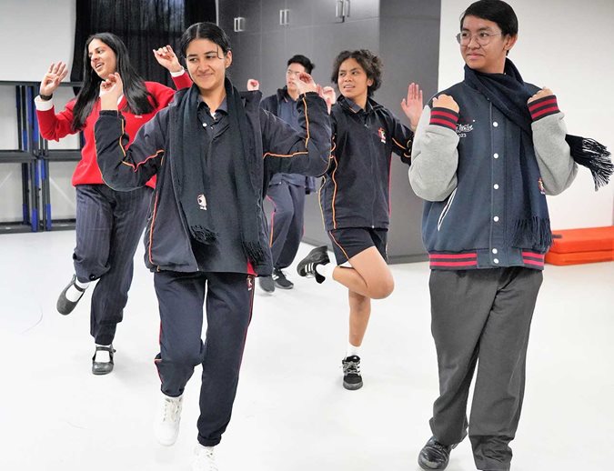 students performing a cultural dance
